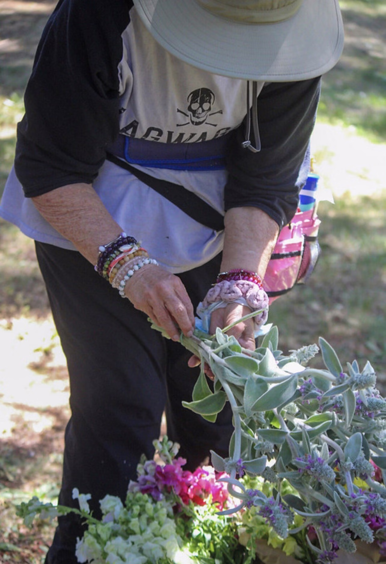 A community member tending an altar of leaves and petals